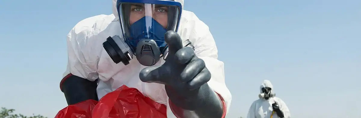 sewage clean up technician wearing protective gear handling biohazard materials in Houston, TX
