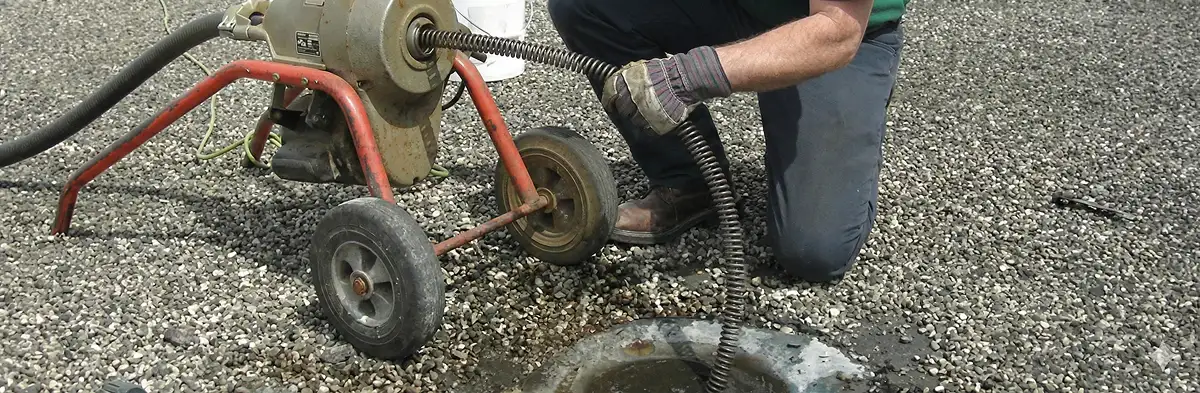 sewer rodding technician actively removing blockages from a sewer line in Houston, TX