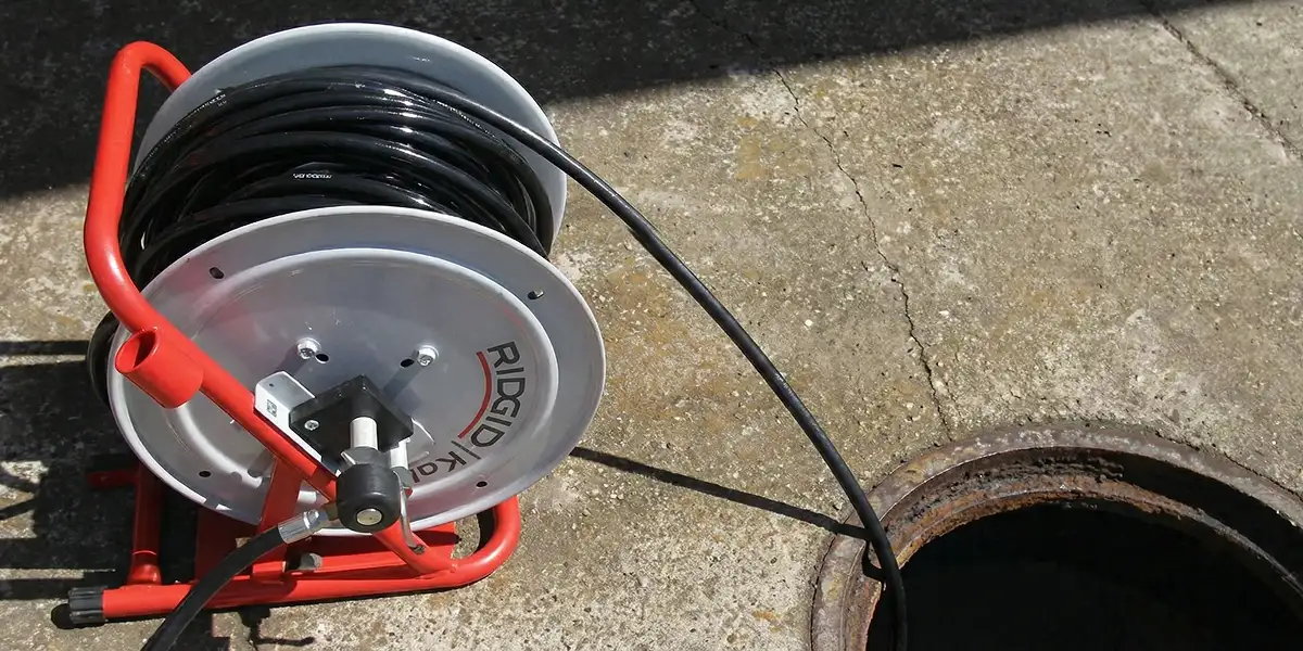 sewer rodding equipment prepared to clear clogged sewer lines in Houston, TX